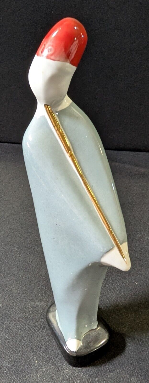 Stylized Porcelain Figurine (Possible Geisha or Figure with a Hat)