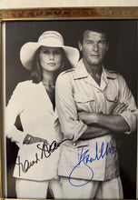 Load image into Gallery viewer, Roger Moore &amp; Barbara Bach Autographed Photo The Spy Who Loved Me James Bond
