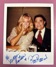 Load image into Gallery viewer, Vintage 1980 Susan Anton &amp; Rex Reed Autographed Polaroid Photograph
